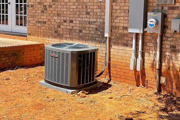 AC-unit-3 AC unit outdoors next to a brick house